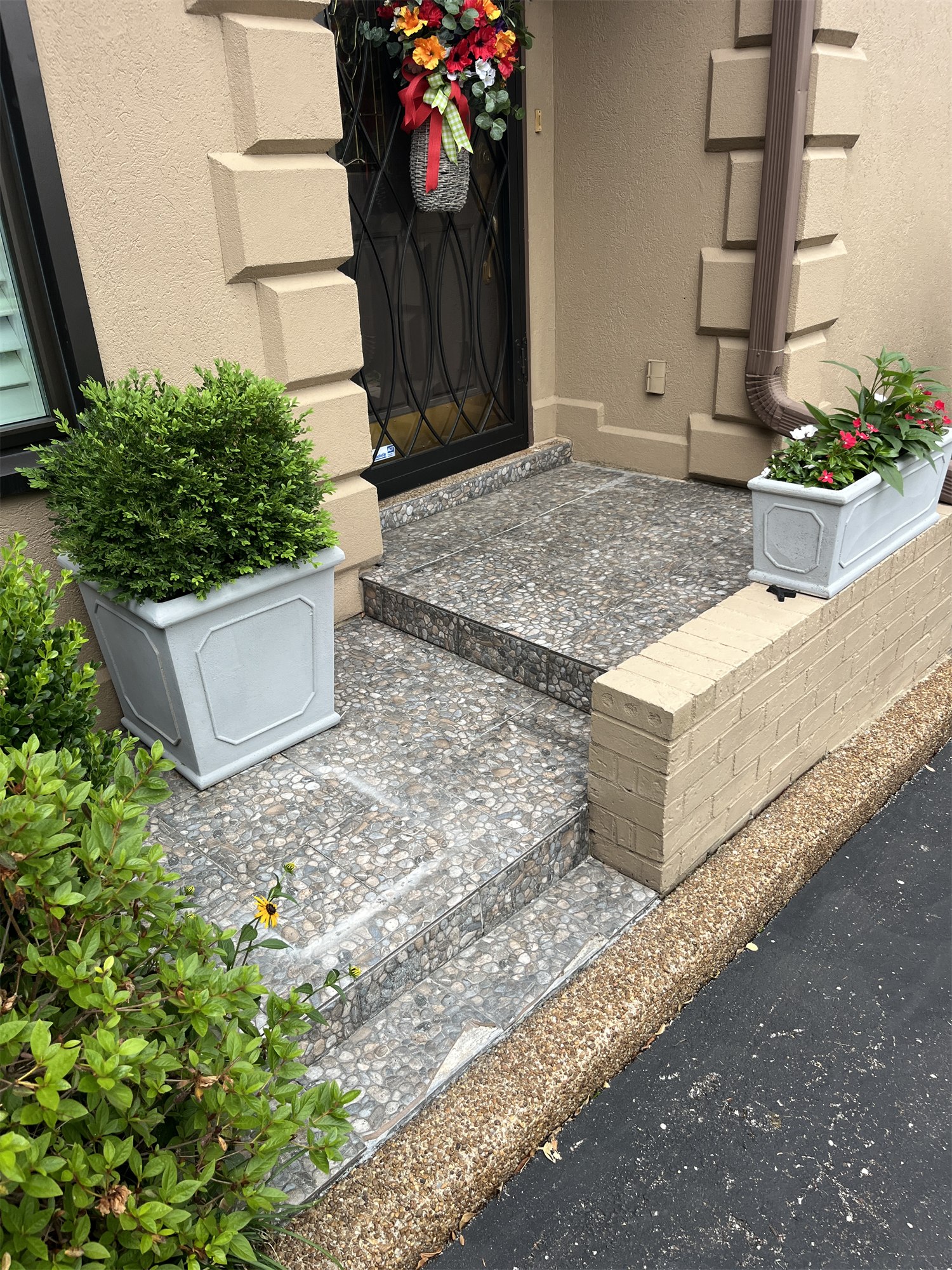 Front entry area before flooring work with the older surface and planters visible