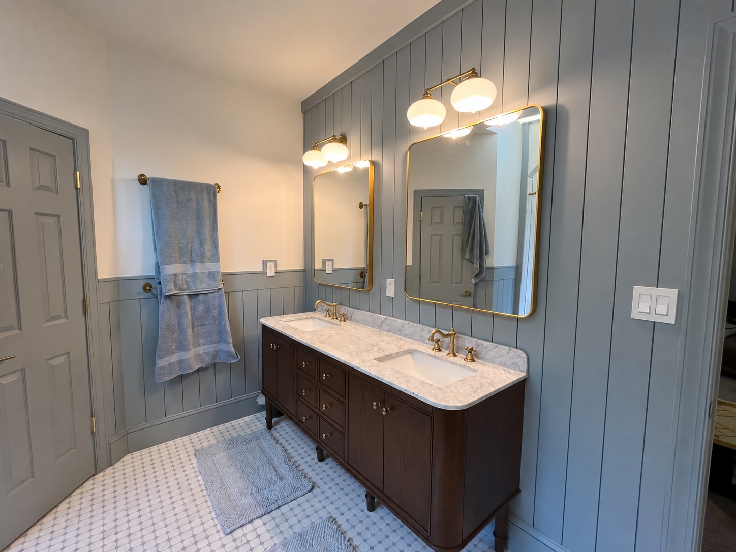 Completed bathroom vanity with blue-gray wall paneling